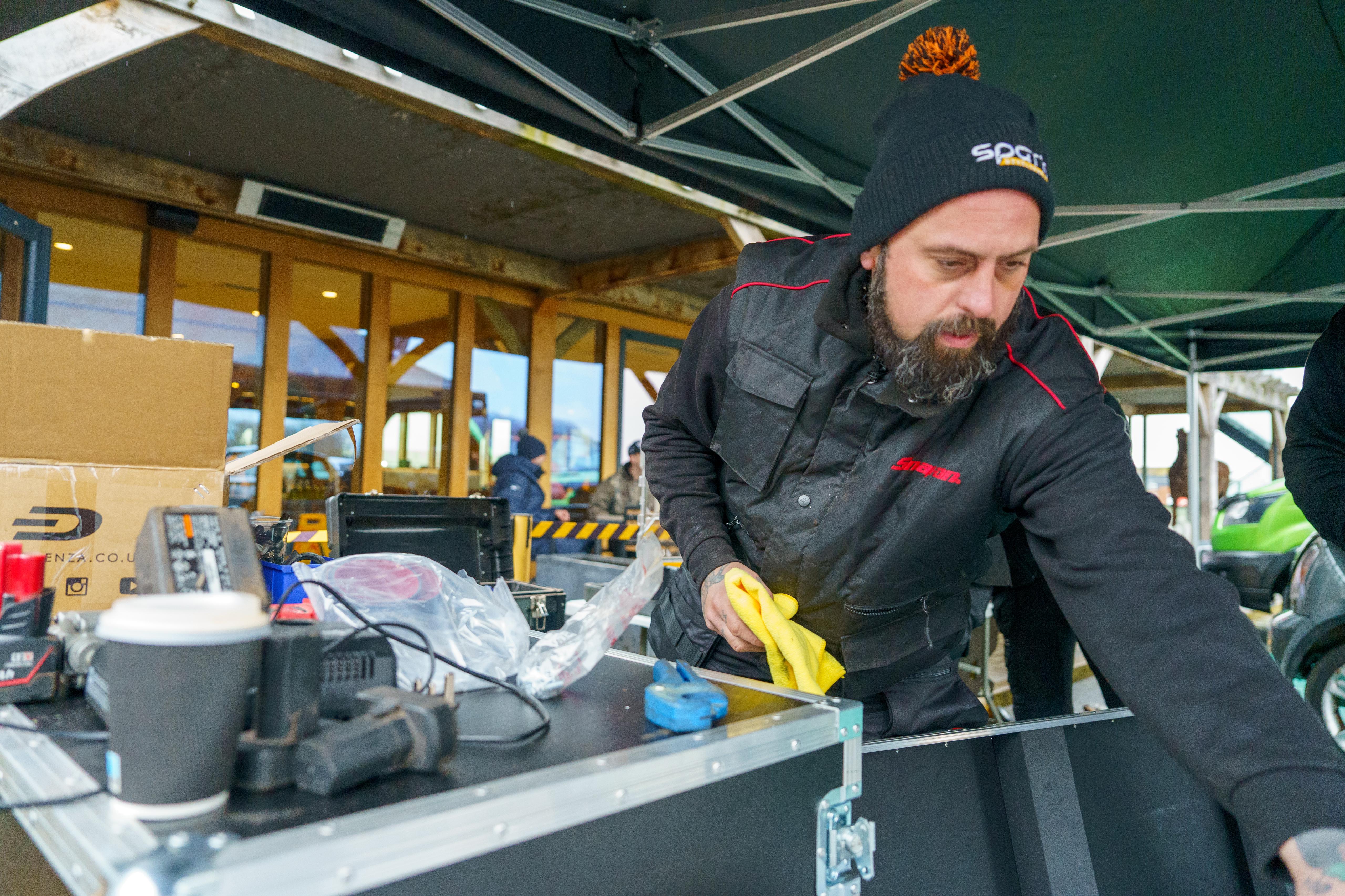 Mechanic reaching for tools